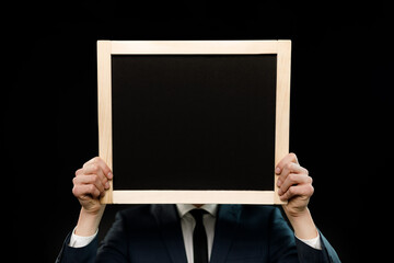 Young businessman is showing the word. Your text here