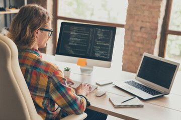 Profile side photo of young man work online computer monitor it specialist website coding sit desk...