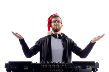 Happy cheerful Bearded man dj in Santa's hat and glasses plays music on a turntable raises hands up.