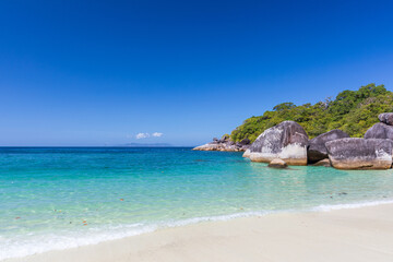 The beautiful and secluded Moken Bay of Boulder Island in Myanmar covering with so many boulders on the beach