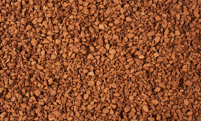 Freeze-dried instant coffee background close-up. Heap of powdered brown coffee product