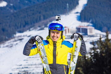 woman in ski equipment on the top of the hill