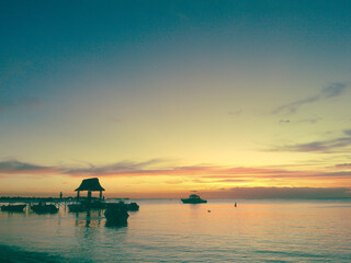 Beautiful sunset at the seashore of Trou aux Biches beach with the pontoon in Mauritius Indian Ocean
