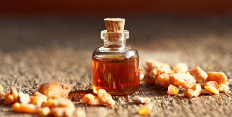 A bottle of styrax benzoin essential oil with benzoin resin