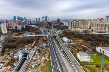 Naklejka premium cityscape with freeway in autumn day filmed from drone 