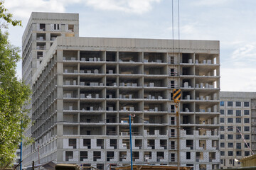 High-rise apartment complex under construction. Construction of walls and facade. Construction site