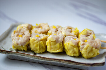 Chinese food shrimp dumplings skewered on white background