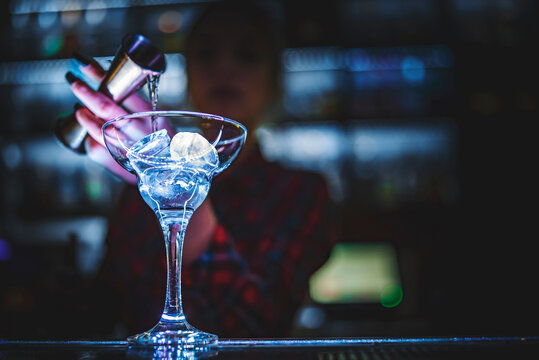 woman bartender hand at the bar or pub to prepare a cocktail