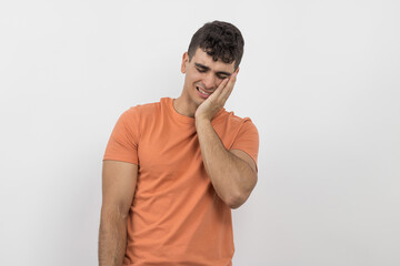 a young boy with a toothache on a white background.
poor mouth hygiene.