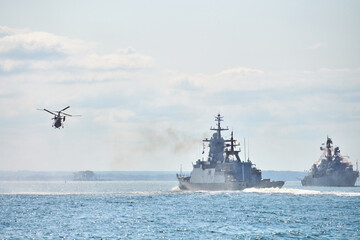 Battleships war ships corvette during naval exercises and helicopter maneuvering over sea, warships
