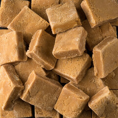 caramelized milk toffee, candy pieces, closeup view taken from above of food background