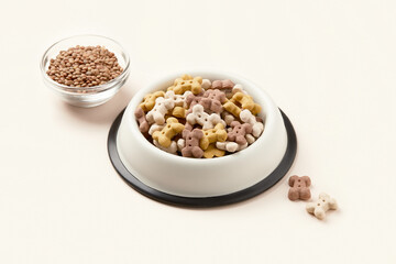 Dry dog vegan vegetarian food concept. Lentils near bowl with pet feed on beige background