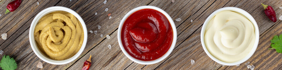 banner of Set of various sauces with spices on natural wooden background. Mayonnaise ketchup mustard.