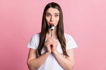 Photo portrait young woman licking spoon hungry isolated pastel pink color background