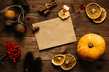 Festive background for recording; top view.An envelope made of craft paper for writing on a wooden table. Autumn-winter. Festive mood.