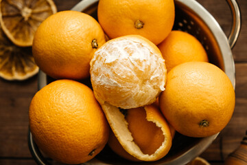 Oranges, cones on a wooden table. Wooden background.