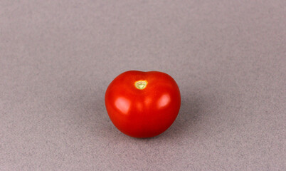 Red tomato on gray background