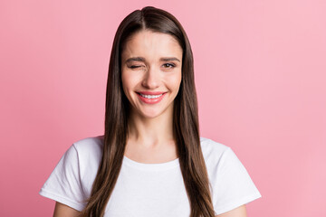 Portrait of attractive cute cheerful long-haired girl winking you good mood isolated over pink...