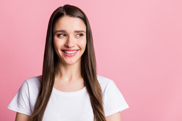 Portrait of attractive cheerful curious long-haired girl looking aside copy empty space isolated...