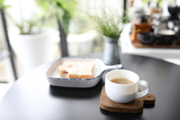 Coffee and sandwich on black table