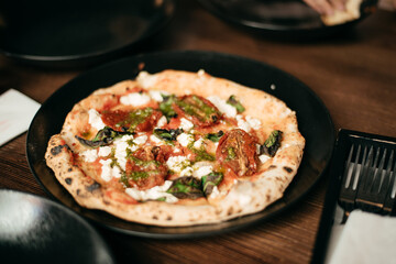 Pizza with fresh basil, tomatoes and cheese