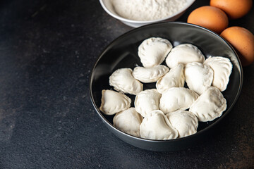 homemade dumplings raw  vareniki stuffed vegetables or meat portion ready to eat meal snack on the table copy space food background rustic. top view