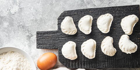 homemade dumplings raw  vareniki stuffed vegetables or meat portion ready to eat meal snack on the table copy space food background rustic. top view