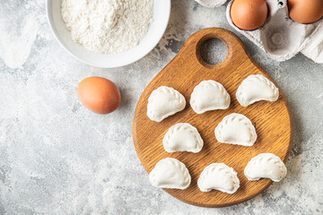 homemade dumplings raw  vareniki stuffed vegetables or meat portion ready to eat meal snack on the table copy space food background rustic. top view