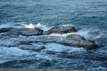 Sea Waves Crashing on the Rocks with White Foam. Swirling frothy foamy sea water over the rock near Akko(Acre) Israel
