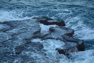 Sea Waves Crashing on the Rocks with White Foam. Swirling frothy foamy sea water over the rock near Akko(Acre) Israel
