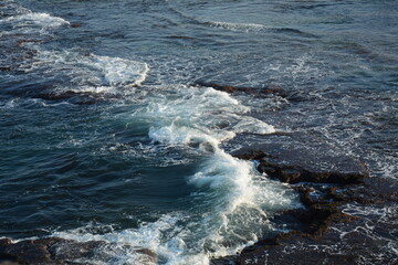Sea Waves Crashing on the Rocks with White Foam. Swirling frothy foamy sea water over the rock near Akko(Acre) Israel