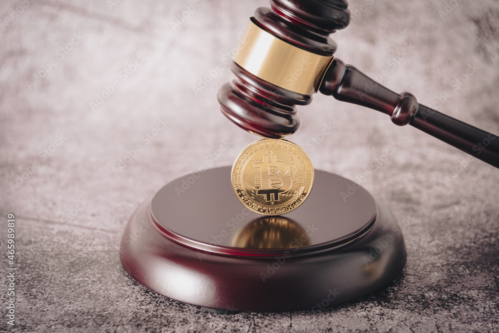 Poster representative cryptocurrency under the judge's gavel in the foreground.