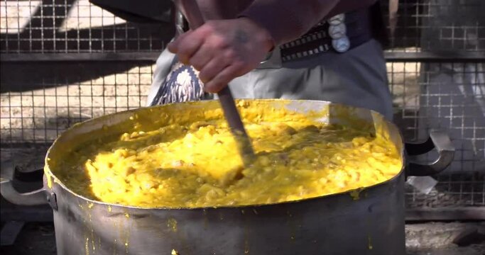 Gaucho cooking locro. Creole Locro. Traditional Argentine food like stew based on corn, squash, potatoes, meat and chorizo. Typical Argentine and South American dish. Winter food and festivities. 