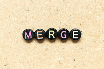 Black color round bead in word merge on wood background