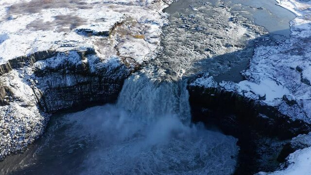 Hafragilsfoss waterfall with snow in autumn 4k aerial view, Iceland
