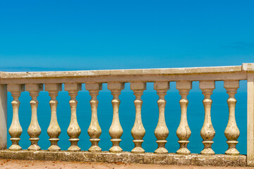Old balustrada against the background of the sea in beautiful sunny weather
