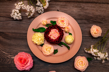 Chocolate pink roses, white roses, peonies on a background of dark wood.