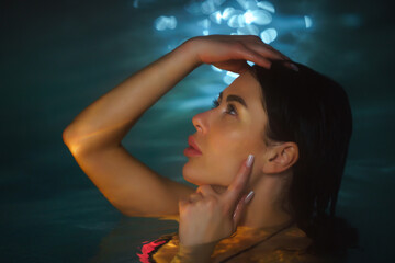 Portrait beauty woman bathing in pool with geothermal water in balneotherapy spa, hot springs...