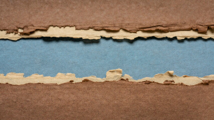 paper abstract in brown, blue and beige with a copy space - sheets of handmade paper, blank web banner, panoramic web banner
