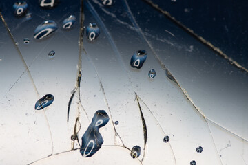 Cracked glass with water drop. Broken glass background with drop of water and reflection on surface. Brake concept wallpaper