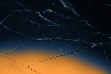 Broken glass background in duotone yellow, orange and blue. Brake concept background wallpaper
