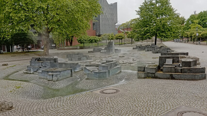 water playground in a city park with green spring trees on an early morning in the city of Cologne, Germany 