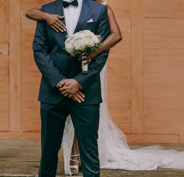 Afro-american bride and caucasian groom posing on a wedding photo shoot