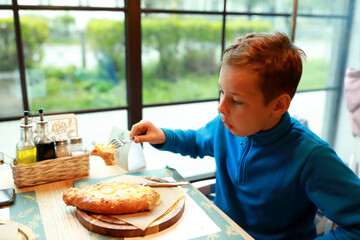 Boy eating Adjarian khachapuri