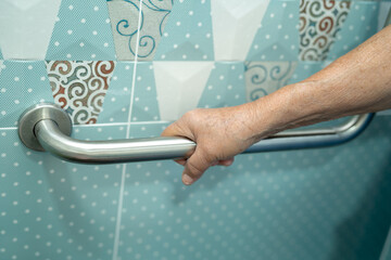 Asian senior or elderly old lady woman patient use toilet bathroom handle security in nursing...