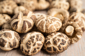 Dried shiitake mushroom on wooden background. Healthy food.