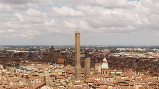 Bologna cityscape with churches and majestic tower, aerial orbit view