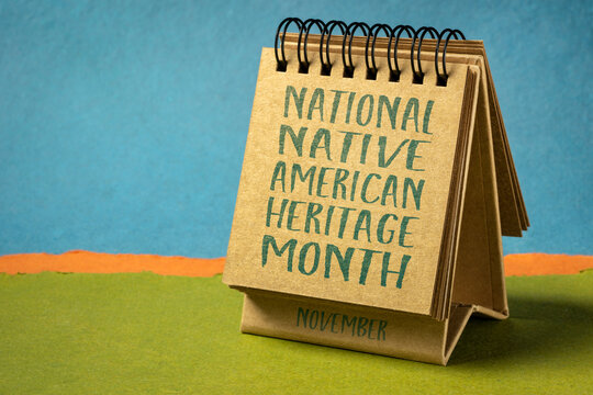 November - National Native American Heritage Month, handwriting in a desktop calendar against abstract paper landscape, reminder of historical and cultural event