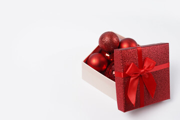 christmas gift box with red balls and bow isolated on white background, copy space . New Year greeting card