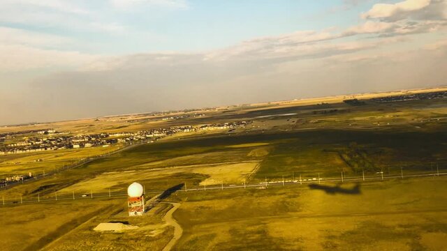 Shadow Of An Airplane Take Off During Sunrise
